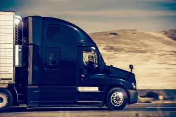 Speeding Dark Blue Semi Truck in Nevada, United States. Trucking in Western USA.